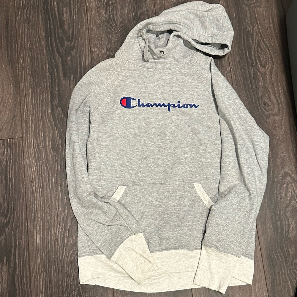 Gray champion hoodie with blue and red logo across chest